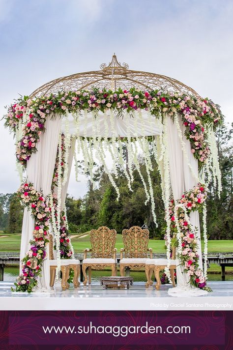 Floral Draped Gold Dome Mandap   #decorbysuhaaggarden #suhaaggarden #stylingwithjilna #floridaweddings #indianweddings #southasianweddings #luxuryeventdesigners #weddingmandap #unforgettablewedding #perfectweddingdecor #mandapdesign #mandap #indianweddingdecor #hinduwedding #floralmandap #floraldesigns #bigfatindianwedding #weddingvows #weddingvenue #weddingstage #weddingambience #flowers #florida #ballroomdecor #weddingguestlist #crazyweddings #bridalbouquet #weddingbouquet Dome Mandap, Buddhist Wedding Ceremony, Indian Mandap, Vidhi Mandap, Pelli Poola Jada, Buddhist Wedding, Big Indian Wedding, Shilpa Reddy, Poola Jada