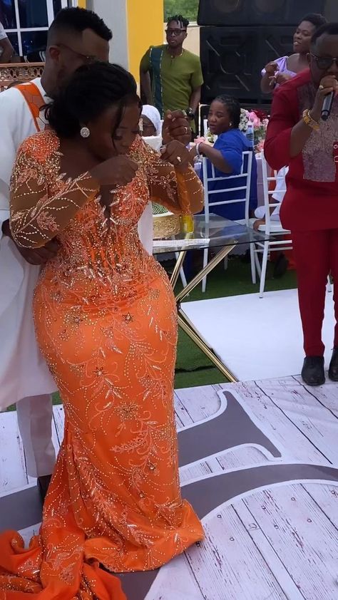 Orang Wedding Dress, Orange Nigerian Wedding Dress, Orange And White Dress Outfit, Lace Style For Wedding Reception, Orange And White Wedding Dress, Couples Reception Outfit, Orange Wedding Dress The Bride, Orange Lace Styles, Traditional Outfits African Wedding