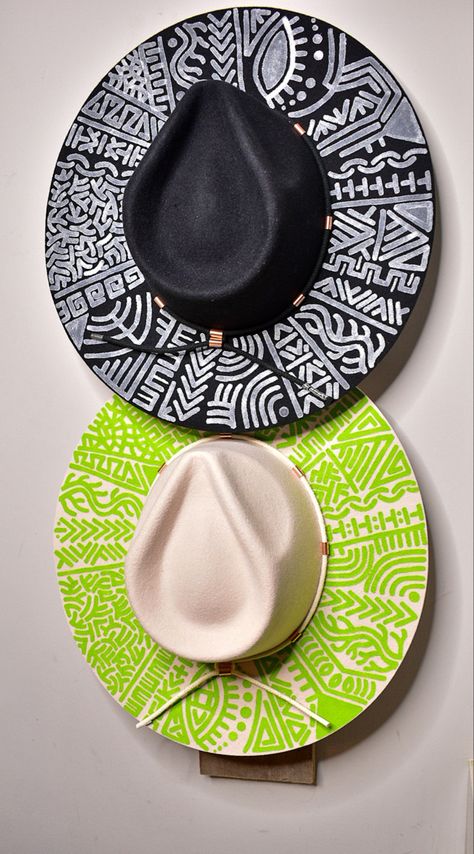 Pictured here is a Black  wool felt fedora with White Hand painting  next to a on a green hand painted fedora by Edged by Echelon. The Artist is Akela Jones. Hat Packaging Ideas, Diy Leather Hat, Green Fedora Hat, Customized Accessories, Custom Made Hats, Rose Hat, Artist Fashion, Small Business Inspiration, Painted Hats