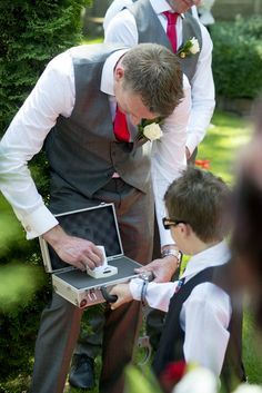 Wedding Photography - Ceremony - Page boy - Ring bearer - Security - Suitcase - Handcuffs - Grey suit - Red tie Blue Line Wedding, Law Enforcement Wedding, Ring Bearer Security, Ring Bearer Boy, Grey Suits, London Wedding Venues, Future Wedding Plans, Wedding Photos Poses, Floral Arrangements Wedding