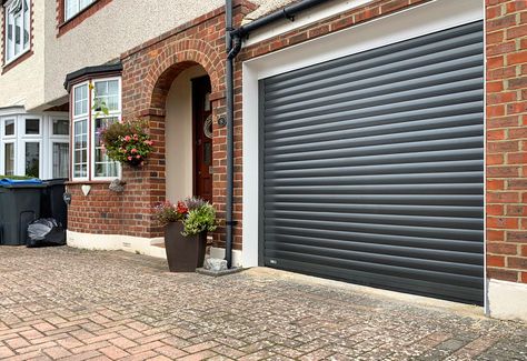 SWS SeceuroGlide Original Insulated Roller Garage Door Finished in Graphite Grey & Installed in Chessington By Our New Malden Branch. We fit all types of Garage Doors including both Retractable and Sectional Garage Doors. Call 0800 716 569 to speak with one of our experts or alternatively, visit www.accessgaragedoors.com to book a free survey. #AccessGD #SWS #rollergaragedoor #newmalden Roller Shutter Garage Doors, Roller Garage Doors, Grey Garage Doors, Bike Storage Garage, Sectional Garage Doors, Bungalow Style House, Modern Gate, Roller Doors, Garage Conversion