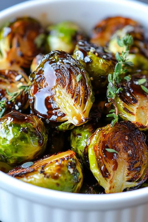 A plate of crispy Brussels sprouts garnished with balsamic glaze, showcasing an appetizing side dish. Perfect for healthy eating or as a delicious vegetarian snack, emphasizing its crispy texture and vibrant colors. Air Roasted Brussel Sprouts, Roared Brussel Sprouts, Cranberry Glazed Brussel Sprouts, Thai Peanut Brussel Sprouts, Ways To Make Brussel Sprouts, Crispy Brussels Sprouts Recipe, Brussel Sprout Lunch, Glazed Brussels Sprouts Recipe, Roasted Brussel Sprouts Appetizer