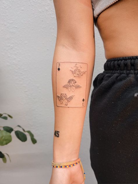 Fine line tattoo of 3 of diamonds playing card with cherubs or baby angels as symbols Angel Card Tattoo, Playing Cards Tattoo, Playing Card Tattoo, Cards Tattoo, Playing Card Tattoos, Cherub Tattoo, Tarot Card Tattoo, Angel Tarot Cards, Angel Card