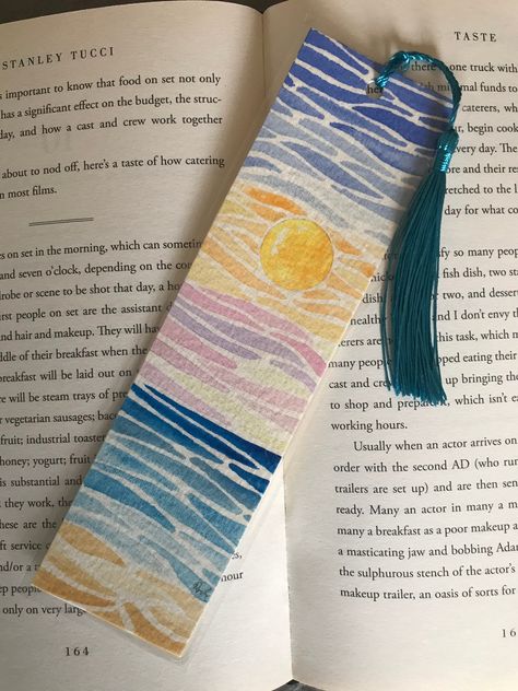 Original sunset watercolour bookmark, laminated and finished with a blue tassel. This is a stunning bookmark to compliment any book. Quality tassels. A beautiful present. Gouache Bookmarks Ideas, Toothless Bookmark, Watercolour Bookmark Ideas, Watercolour Bookmarks Easy, Hand Painted Bookmarks, Paint Chip Bookmarks, Book Mark Art, Watercolor Bookmark Ideas, Watercolor Bookmarks Ideas