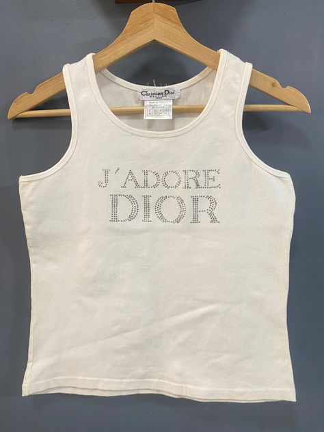 VINTAGE J'adore Dior Christian Dior rhinestone tank top ❤️DETAILS❤️Brand : Christian Dior 💥Material :95%cotton :5% Lycra 💥Colour : white 💥Madi in FRANCEsize :  Armpit to Armpit =15.5inch Length = 19 inch CONDITION : ( good vintage condition) NO RETURN / NO SWAP .OFFER ME YOUR BEST PRICE.  ✈️Shipping Item will be ship in 3 working days after purchase. It will take 3-5 working days to reach at destination. We are using DHL Express with tracking number.   💰Offer If you make offer, be prepare th Dior Monogram Outfit, Jadore Dior Tank Top, Jadore Dior Tshirt, Vintage Dior Aesthetic, Dior Tank Top, Vintage Tanks, Dior Clothes, J Adore Dior, Rhinestone Tank Top