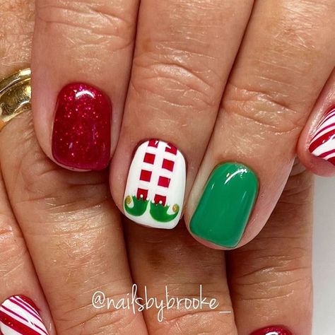 Brooke Jensen on Instagram: "These elf nails…are we kidding😍🎄👏🏼♥️ Believe it or not, this client has never seen the movie, Elf!!😱 But considering it’s in theaters for the 20th anniversary….might just be the year she finally sees it!!😏🎉 . . . . #gelpolish #handpaintednailart #naturalnailsonly #utahnailtech #utahnailartist #nailartist #nailart #naildesigns #nailartdesigns #freehandart #freehandnailart #gelnails #nails #nailmagazine #nailinspo #holidaynails #christmasnails #christmasnailart #decembernails #trendychristmasnails #festivechristmasnails #elfnails #elfnailart #elflegnails #peppermintnails #peppermintcandynails #candycanenails #candycanenailart #redglitternails #nailsbybrooke___Christmas" Elf Nail Designs, Christmas Elf Nail Art, Elf Inspired Nails, Christmas Nail Art Grinch, Elf Nails Christmas, Buddy The Elf Nails, Christmas Nails Design Ideas, Grinch Nails Short, Elf Christmas Nails