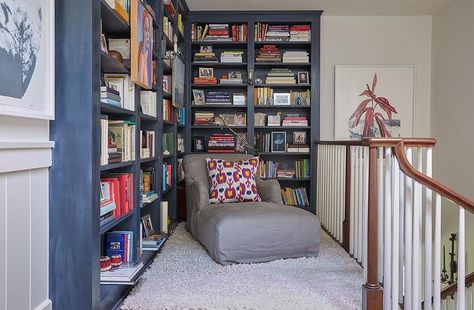 Second floor landing designed with reading nook showcasing gray wash built-in bookcases, a dark gray roll arm chaise lounge and a faux fur accent rug. Dark Stained Wood Floors, Built In Bookcases, Den Library, Grey Floating Shelves, Floor To Ceiling Bookshelves, Upstairs Landing, Second Floor Landing, Grey Shelves, Library Office