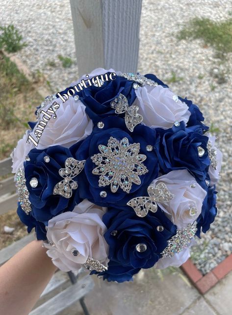 An elegant and beautiful bouquet! Customize bouquets are also available if needed. Different colors and brooches. 10inches in diameter You are welcome to message me and I will reply quick :) Hablo español 😊 Royal Blue And Gold Quince Bouquet, Quinceanera Flower Bouquet Blue, Royal Blue Ramo Quince, Quince Blue Decorations, Royal Blue Bouquet Quinceanera, Royal Blue Quince Bouquet, Royal Blue Xv Decorations, Royal Blue Ramo, Blue And Silver Quinceanera Ideas