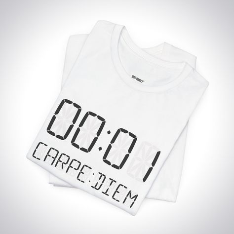 A POWERFUL MANTRA FOR THE PRESENT MOMENT This minimalist yet impactful design symbolizes the philosophy of seizing the day and living life to the fullest. The bold "00:01" numbering represents a single second - the smallest unit of time, yet one that holds infinite potential. Paired with the Latin phrase "carpe diem" meaning "seize the day," it delivers a potent reminder to value and take advantage of every fleeting moment. ABOUT THE DESIGN The shirt comes in a sleek black or white colorway w... Carpe Diem Meaning, Fleeting Moment, Unit Of Time, Stay Present, Living Life To The Fullest, Latin Phrases, Seize The Day, Philosophical Quotes, The Present Moment