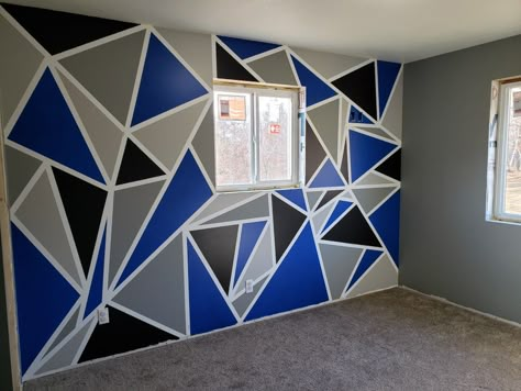 Geometric accent wall with light grey, dark grey, black and blue. The other walls are the dark grey. Black And Blue Wall Painting Ideas, Grey Wall Design Pattern, Geometric Wall Paint Patterns Blue, Blue Triangle Wall Paint, Geometric Wall Paint Blue, Wall Painting Ideas Bedroom Boys, Wall Painting Ideas Geometric, Painting Ideas Geometric, Triangle Accent Wall