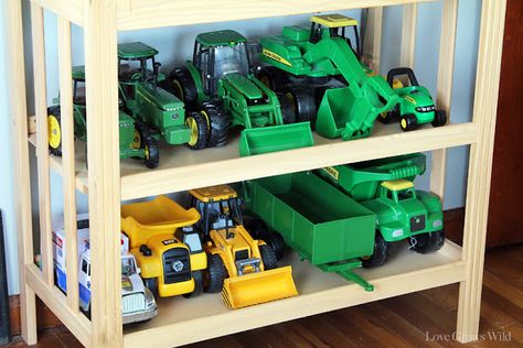 Kid's Playroom Makeover with lots of organizing tips and decor ideas! #playroom #kids #decor Kids Truck Storage, Toy Car And Truck Organization, Big Toy Truck Storage Ideas, Toy Tractor Storage Ideas, Tractor Toy Storage, Tonka Truck Storage Ideas, How To Store Large Toy Trucks, Toy Tractor Storage, Toy Truck Storage