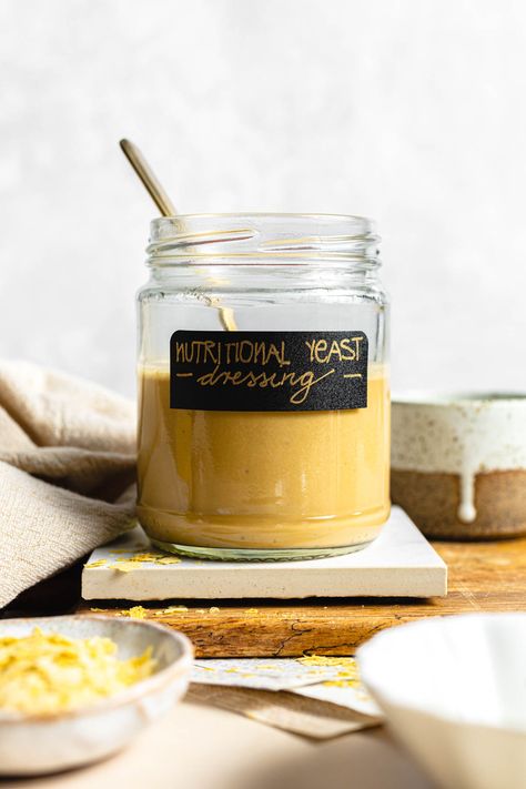 This creamy nutritional yeast dressing is a powerhouse of essential vitamins and irresistible umami flavor. It's made in minutes and tastes SO GOOD. Elevate your salads and grain bowls with it, or simply use it as a dip. Made in minutes, this nooch dressing is an unexpected explosion of flavors - garlicky, salty, tangy. If you're bored of your Caesar dressing and want to switch things up, give this homemade dressing a go! Addictingly cheesy, no tools required, rich in nutrients and versatile! Nutritional Yeast Dressing, Vegan Halloumi, Low Calorie Recipes Dessert, Grain Bowls, Calorie Recipes, Grain Bowl, Caesar Dressing, Homemade Dressing, Food Photography Tips