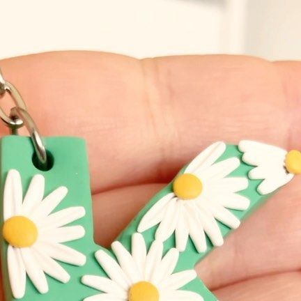 Lazy Daisy Creations ✨Polymer Clay Earrings✨ on Instagram: "✨Custom Letter Keychain✨ These are by far the BEST sellers on my website!! They are completely customisable, you pick the letter, the background colour and the daisy colour(s)😍😍😍 It’s the perfect accessory and even more perfect gift for those who love polymer clay but can’t wear earrings!! Love this green and white combo 😍 what do you guys think? What colours would you pick? #keychain #custom #letter #alphabet #customized #daisy #cu Keychain Custom, Polymer Clay Flower Jewelry, Letter Keychain, Clay Flower, Polymer Clay Flowers, Custom Letters, Flower Jewelry, Flower Jewellery, Green And White