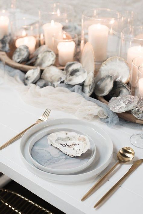 a neutral beach wedding tablescape with fabric runners, seashells, candles, watercolor porcelain and gold cutlery Beach Wedding Table Settings, Nautical Wedding Centerpieces, Nautical Wedding Favors, Beach Wedding Tables, Beach Wedding Decorations Reception, Romantic Beach Wedding, Nautical Wedding Theme, Beach Wedding Inspiration, Romantic Beach