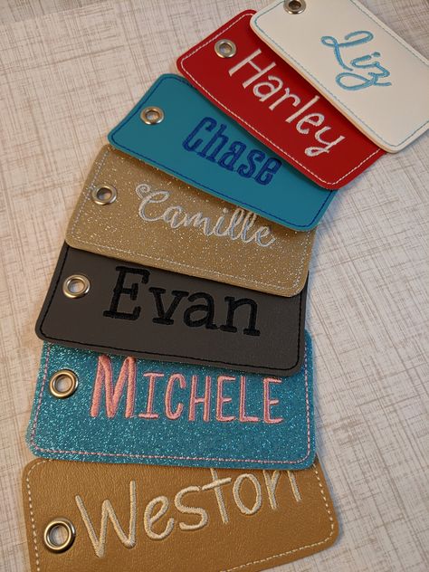 "Personalize your own luggage tag! Can also be used for backpacks, laptop bags, gym bags, or diaper bags. Makes a great personalized wedding, graduation, or birthday gift as well. This luggage tag is made with vinyl which is durable and easy to clean. The tag measures approx. 2.5\" tall by 4.5\" wide. The back vinyl and thread matches the front giving them a very professional, finished look. The tags are attached with a high quality, flexible, clear plastic 6\" luggage loop. These are completely Luggage Name Tag, Fabric Luggage Tags, Sew Luggage Tags, Embroidery Luggage Tags, Machine Embroidery Name Tags, Embroidered Luggage Tags, Luggage Tag Designs, Personalized Bag Tags, Name Embroidery