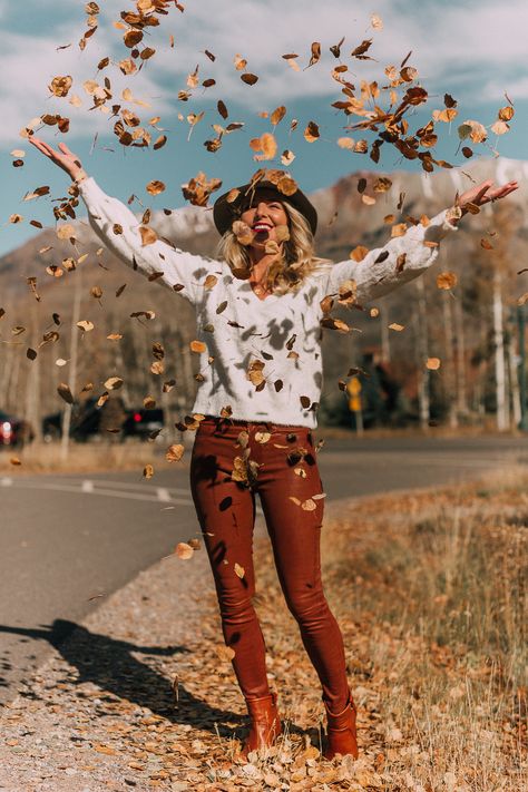 Blonde woman in Telluride, Colorado wearing brown leather pants by Frame with a white fuzzy Halogen sweater, Saint Laurent boots, and a rag & bone hat, throwing leaves in the air Autumn Aesthetic Tumblr, Autumn Photography Portrait, Portret Feminin, Fall Portraits, Shotting Photo, Photographie Portrait Inspiration, Fall Photoshoot, Trik Fotografi, Fall Pictures