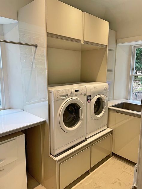 Laundry room makeover with IKEA kitchen cabinets. Washing machine and dryer are set on pedestals with a pull out tray for the laundry basket. Ikea Washing Machine Cabinet, Ikea Laundry Room Ideas, Ikea Laundry Room Cabinets, Laundry Basket Shelves, Washer And Dryer Pedestal, Ikea Laundry, Ikea Sinks, Ikea Laundry Room, Besta Ikea