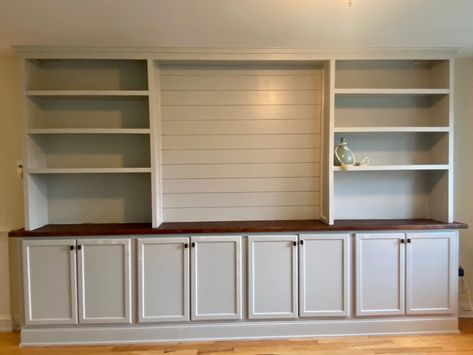 Built In Cabinet With Floating Shelves, Stock Cabinets For Built In Dining Room, Bookcase With Cabinet Base, Shiplap Bookcase, Stock Cabinets For Built In, Den Cabinets, Diy Built In Cabinets, Basement Dry Bar Ideas, Livingroom Storage