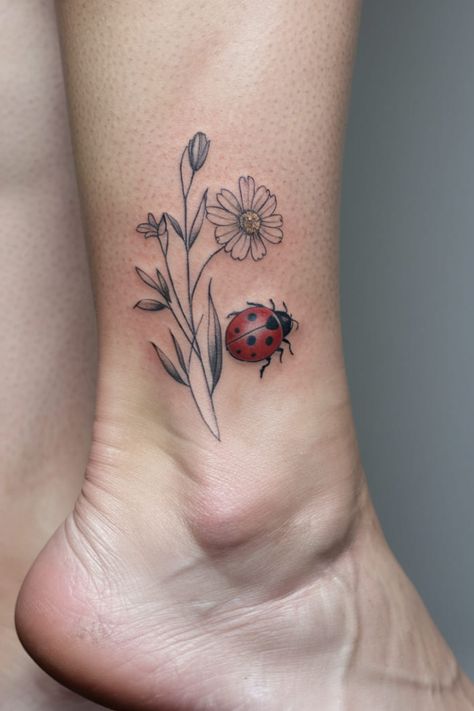 A tiny wildflower paired with an even tinier ladybug on the ankle brings a playful twist to the design. The small red insect adds a pop of color and playfulness to the otherwise minimal floral tattoo. Doodlebug Tattoo, Dainty Wildflower Tattoo, Small Ladybug Tattoo, Wildflower Tattoo Ideas, Red Insects, Wildflower Crown, Dahlia Tattoo, Ladybug Tattoo, Dna Tattoo