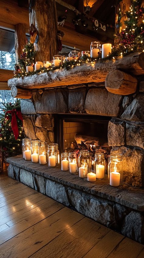 Rustic stone fireplace with glowing glass candle jars and festive decorations, creating a cozy holiday ambiance in a Mountain Stone Fireplace, Floor Decor In Front Of Fireplace, Fireplace With Candles Inside, Fireplace Candles Inside, Cozy Christmas Mantle, Fireplace With Candles, Holiday Fireplace Decor, Farmhouse Kitchen Dining Room, Christmas Mantle Ideas