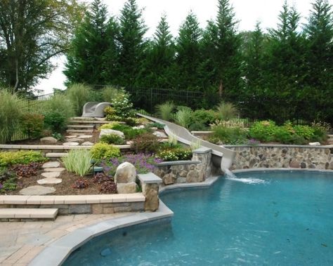 Swimming Pools Backyard Side Of Hill, Pool Slide Landscaping, Pool Landscaping Hillside, Rectangle Pool With Grotto, Sloped Backyard Landscaping With Pool, Pool With Sloped Backyard, Backyard Pool Slide, Pool Sloped Backyard, Hillside Pool Sloped Backyard