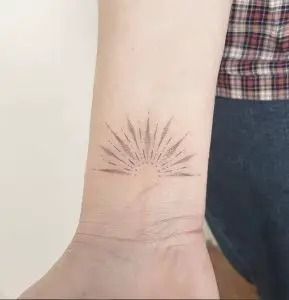 Sunburst Tattoo: Meaning, Placement & Design Ideas - Tattoo Twist Sunburst Tattoo, Dotwork Tattoo Mandala, Simple Line Tattoo, Ray Tattoo, Egyptian Tattoo Sleeve, Chic Tattoo, Light Tattoo, Dot Tattoos, C Tattoo