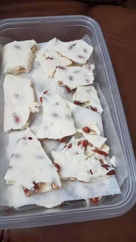 Stir up this white chocolate bark with almonds and almond flavoring for a sweet treat that can be a thoughtful gift for the holidays. White Chocolate Almond Bark Recipes, White Chocolate Wafer Recipes, White Bark Candy, Ghirardelli White Chocolate Recipes, White Bark Recipes, Vanilla Almond Bark Recipes, Almond Bark Fudge Easy Recipes, White Almond Bark Recipes Christmas, Almond Bark Recipes White