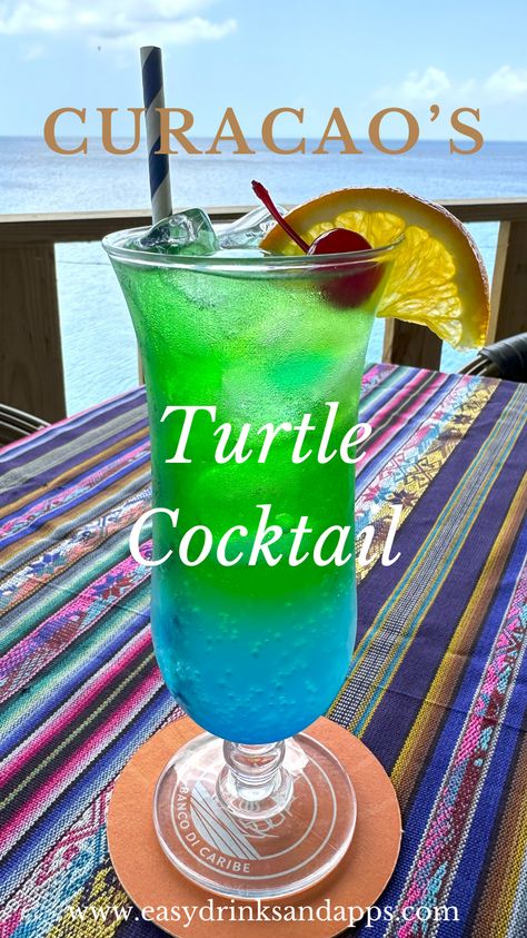 The Turtle Cocktail from Playa Forte Restaurant in Curacao is a must-try. With its enticing blue and green hues, this vibrant drink combines vodka, blue and green curaçao, lemon juice, and ginger ale, offering a refreshing twist perfect for a tropical setting.  Playa Forte Restaurant is known for its scenic beachside location and menu that captures the essence of Caribbean cuisine. Inspired by the island’s love for sea turtles, the Turtle Cocktail has become a signature drink. Turtle Cocktail, Green Alcoholic Drinks, Curacao Drink, Passing The Bar Exam, Diy Bars, Blue Curacao Drinks, Curacao Beaches, Passing The Bar, Portable Bars