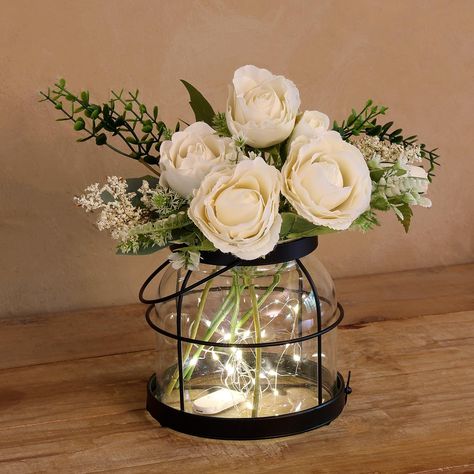 PRICES MAY VARY. RUSTIC DECOR VASE - This vintage glass vase features a clear glass jar encased in a rustic black metal frame, adding a touch of rustic charm to any home decor. Perfect for creating a cozy and welcoming atmosphere. VINTAGE FARMHOUSE VASE - Elevate your home decor with this beautiful Vintage Glass Vase. Designed with inspiration from rustic farmhouse style, this vase features a glass jar encased in an black metal frame. It comes with 1 bundle artificial flowers and 1 LED light str Rustic Lantern Decor, Red Roses Centerpieces, Decor With Plants, Mason Jar Fairy Lights, Home Decor Floral Arrangements, Vintage Glass Vase, Farmhouse Vase, Lighted Centerpieces, Lantern Decor