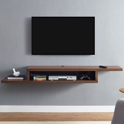 A floating wooden TV stand that'll add a modern illusion to your room while giving you extra room for storage — don't blame me if the remote *magically* disappears. Wall Mounted Tv Console, Entertainment Shelves, Wall Tv Stand, Wall Mount Tv Stand, Tv Stand Bookshelf, Tv Regal, Tv Stand Cabinet, Floating Tv Stand, Floating Tv