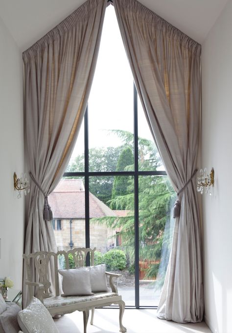 Bespoke curtains created for the clients high arched feature window in this stunning bedroom.
(using a scaffold tower and a steady hand to hang them!) Dormer Window Curtain Ideas, Curtains On Angled Ceiling, Angle Window Curtains, Curtains For Angled Windows, Angled Window Treatments, Angled Curtains, Apex Window Curtains, Triangle Window Curtains, Arch Window Curtains