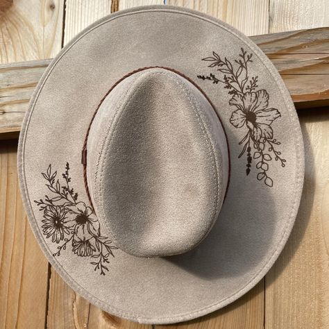 Embrace the spirit of Bohemia with Bow'Ho & Co's exclusive Faux Suede Burned Boho Panama Hat, adorned with an exquisite floral design. Each hat is a piece of wearable art, featuring a digitally crafted, laser-engraved floral pattern that evokes a sense of natural elegance. Our hats are available in a palette of five earth-inspired colors: taupe, charcoal, black, caramel, and olive. They perfectly capture the essence of bohemian style while offering versatility to match any outfit. Crafted from s Burning Hats, Cowgirl Hats Western, Bohemian Hats, Cowboy Hat Design, Custom Cowboy Hats, Painting Flowers Tutorial, Felt Cowboy Hats, Boho Hat, Painted Hats