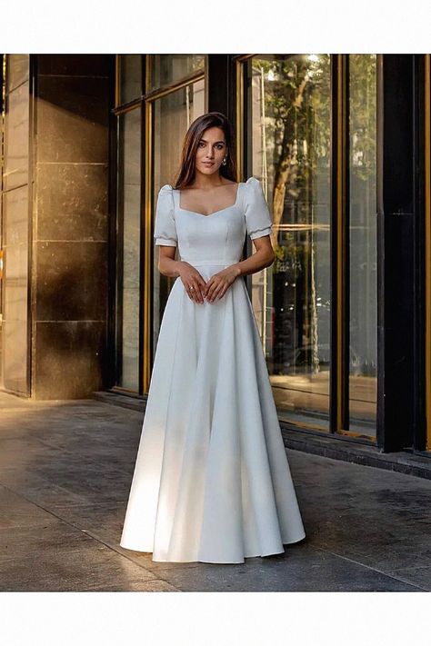 A classic minimalist dress feels chic for any bride. The experts selected this one for its clean lines. Pin it to your wedding board. Wedding Dress Fancy, Fancy Sleeves, Long White Wedding Dress, Courthouse Wedding Dress, Crepe Wedding Dress, Dress Fancy, Minimalist Wedding Dresses, Silk Wedding Dress, Minimalist Dresses