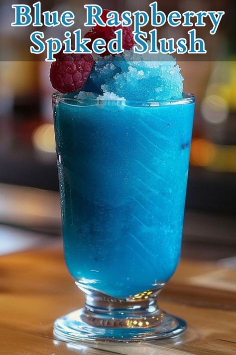 Blue Raspberry Spiked Slush is a refreshing and vibrant cocktail perfect for cooling down on a hot day. This icy drink combines raspberry vodka, blue curaçao, lemon juice, and simple syrup, blended with ice to create a frosty treat that’s as visually appealing as it is delicious. Raspberry Drink Recipes, Raspberry Vodka Drinks, Alcoholic Slush Recipes, Alcoholic Slush, Blue Curacao Drinks, Vodka Blue, Slushy Drinks, Raspberry Drink, Slush Recipes