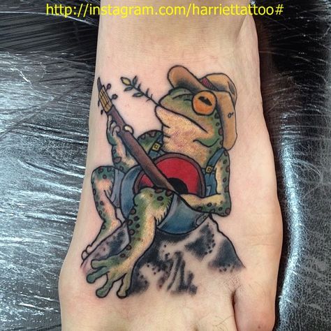 Frog playing banjo tattoo by me Frog Playing Banjo On Mushroom, Frog With Banjo Tattoo, Animal Playing Banjo Tattoo, Frog Tattoos Traditional, Frog With Guitar Tattoo, Sitting Frog Tattoo, Frog Guitar Tattoo, Frog Playing Guitar Tattoo, Banjo Frog Tattoo