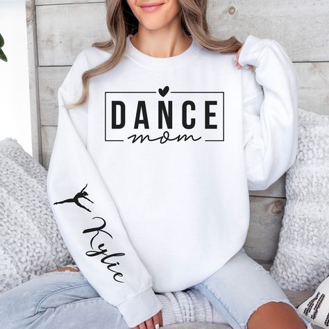 Elevate your dance mom style with our personalized sweatshirt featuring the "Dance Mom" title proudly printed on the chest, and your dancer's name elegantly displayed on the right sleeve. Crafted for comfort and style, this sweatshirt celebrates the dedication and pride of every dance mom, making it the perfect way to showcase your support with a touch of personalization. - 50% cotton/50% polyester blend - Loose unisex fit - Medium-heavy fabric - Sewn-in label HOW TO ORDER Please select your des Dance Mom Svg, Dance Mom Gifts, Ballet Mom, Sweater Svg, Dance Mom Shirt, Dance Sweatshirt, Dance Svg, Dance Mom Shirts, Svg Ideas