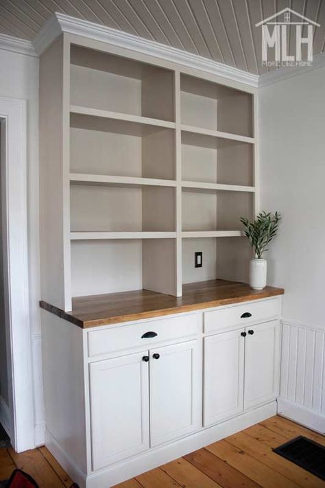 Bookshelf With Bottom Cabinet, Kitchen Cabinets As Built Ins, Diy Built Ins Using Stock Cabinets, White Bookshelf With Wood Shelves, Den Cabinets Built Ins, Diy Bookcase With Cabinets, Built In Shelving Kitchen, Built In Bookshelf With Cabinet, Built In Shelves With Cabinets