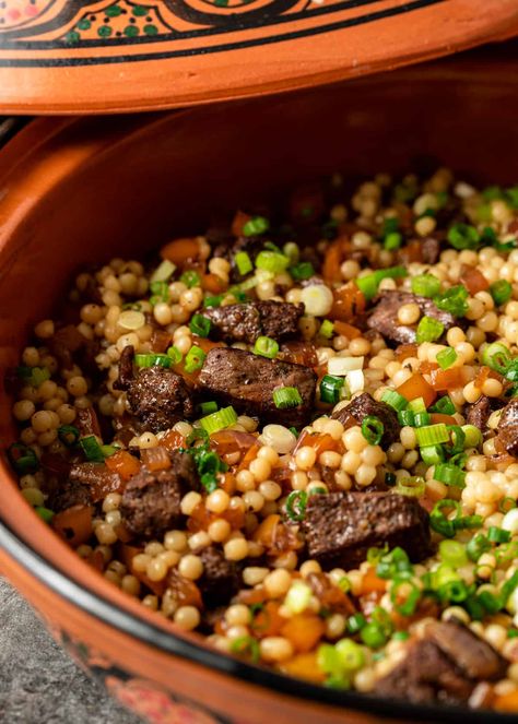 This lamb and pearl couscous recipe is a mouthwatering combination of marinated lamb, sauteed veggies, and fluffy pearl couscous. Lamb And Couscous, Lamb And Couscous Recipes, Lebanese Couscous Recipes, Lamb Couscous Recipes, Lamb Sausage Recipes Dinners, Pearl Cuscus Recipes, Lamb Cubes Recipes, Roasted Couscous, Giant Couscous Recipes