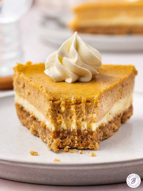 This Layered Pumpkin Cheesecake is the best combination of two dessert favorites, including a creamy cheesecake base, a layer of spiced pumpkin cheesecake, and a graham cracker crust. It's the perfect way to satisfy both pumpkin pie and cheesecake lovers at holiday time! No Bake Pumpkin Pie Cheesecake, Pumpkin Pie Cheesecake Recipe, Layered Pumpkin Cheesecake, Pumpkin Banana Muffins, No Bake Pumpkin, Pumpkin Pie Cheesecake, Pumpkin Cheesecake Recipes, No Bake Pumpkin Pie, Pie Cheesecake