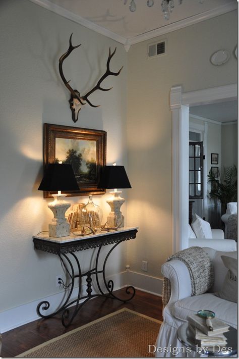 really like the antlers.....lamps.... console............. Dear Mount Decor, Duck Mounts In Living Room, Antlers On Wall, Deer Mount Wall Arrangement, Deer Antler Wall Decor, Antler Mounts, Til The Cows Come Home, Decorating With Antlers, Vintage Entryway