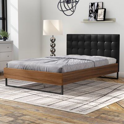 Latitude Run® This Upholstered Platform Bed combines solid wood, metal and upholstery into a modern piece of bedroom furniture. Constructed of solid wood frame and finished in walnut Arcacia veneer, this collection is built to last. The bed frame is designed to be striking and bold, while allowing the wood to float. Featuring angular industrial details, the dark bronze powder coated steel legs help to give structure and form to the piece while the upholstered headboard, overly padded and with gr Platform Bed Headboard, Bed Headboard Wood, Philadelphia Apartment, Walnut Bed Frame, Headboard Wood, Leather Platform Bed, Colorful Headboard, Walnut Bed, Leather Headboard