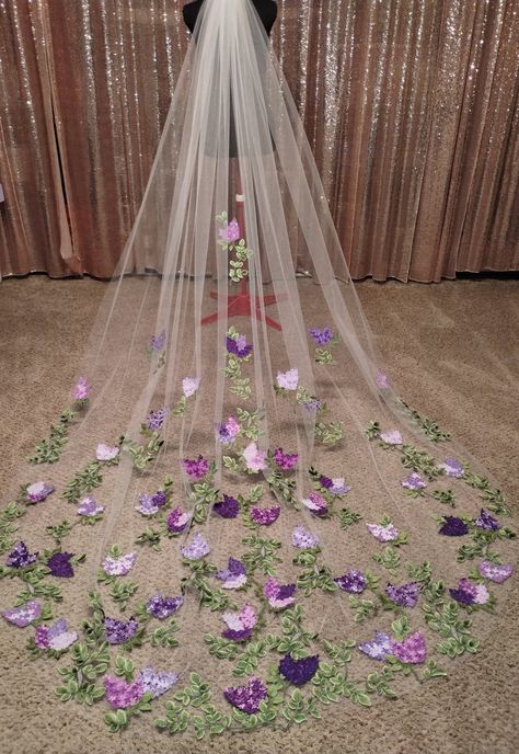 The Lilac Veil is a 10-foot cathedral, made with ivory tulle, green vines, and purple Lilacs embroidered in many shades. Lilacs are all embroidered with a custom blend of thread colors to look as real as possible. The colors are fully customizable to your wedding palette, and I love custom orders so please reach out with any questions! Lilac And Wisteria Wedding, Wedding Ideas Light Purple, Purple Gray And White Wedding, Purple And Silver Wedding Flowers, Subtle Rapunzel Wedding, Lavender Lilac Wedding, Wedding Light Purple Theme, Pink Purple And Sage Wedding, Black Gold Lavender Wedding