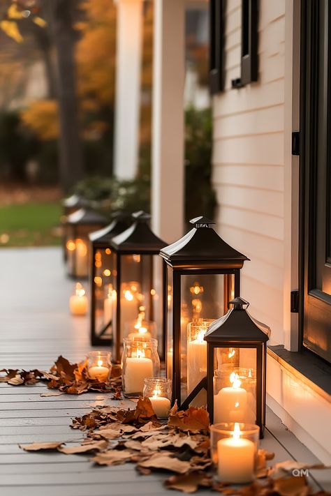 Cozy fall decor with lanterns and candles illuminating a porch, surrounded by scattered leaves. Perfect fall home vibes and outdoor fall decorations. Minimalist Centerpieces, Fall Outdoor Decorating, Traditional Fall Decor, Metal And Concrete, Minimalist Centerpiece, Minimalist Holiday Decor, Outdoor Decorating Ideas, Minimalist Home Design, Modern Fall Decor