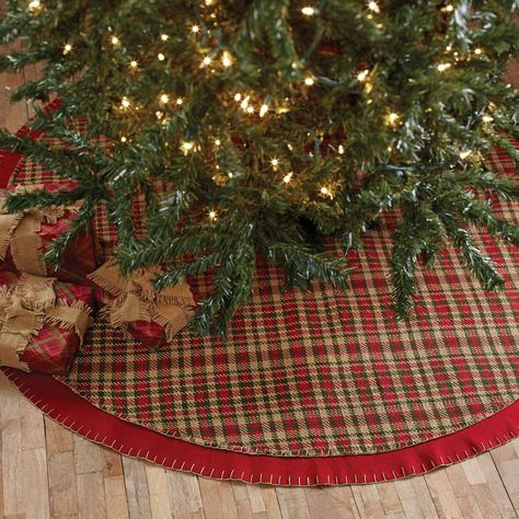 Claren Tree Skirt 48" Tree skirts add a touch of style beneath your tree when you decorate for the holidays. This Claren Tree skirt is perfect for bringing a woodsy, country look to your room when you use it to complete your Christmas Tree.. It measures 48" in diameter. The front displays a cherry red, forest green, and khaki plaid woven fabric with detailed stitching. There is a 2" cherry red felt border that also displays detailed stitching to complete the simple charm of this accent. There ar Rustic Tree Skirt, Rustic Christmas Tree Skirts, Plaid Tree Skirt, Fringe Tree, Glam Christmas Decor, Vhc Brands, Traditional Christmas Decorations, Country Christmas Decorations, Red Tree