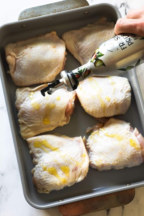 The flavor of these perfectly roasted chicken thighs is incredible. This easy 5-ingredient oven-baked bone-in chicken thigh recipe is the perfect staple recipe and easy weeknight dinner. These low-carb chicken thighs are super-juicy with the crispy skin you want. Use this recipe for meal prep and batch cooking too. | Real Simple Good Skin On Chicken Thigh Recipes Oven Baked, Quick Bone In Chicken Thigh Recipes, Skinned Chicken Thigh Recipes, Chicken Thigh Marinade For Oven, Baked Chicken Thigh Recipes Bone In, Recipes For Bone In Skin On Chicken Thighs, Chicken Thighs With Bone And Skin, Cast Iron Chicken Thigh Recipes, Chicken Recipes Bone In