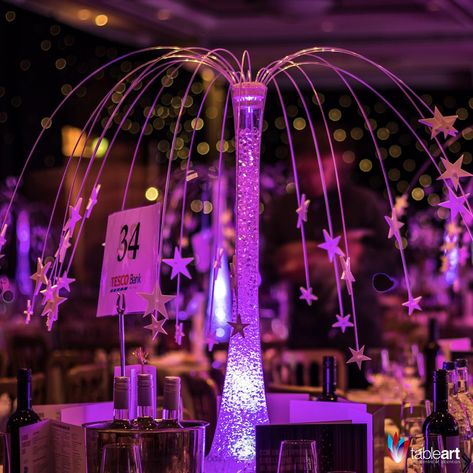 Under a canopy of Stars, guests will feel transported as they look up to the night sky. The Star Fountain table centre adds an ethereal beauty to any event. Under The Stars Quinceanera Theme, Starry Night Prom, Night To Shine, Glow Table, Sweet 16 Centerpieces, Star Centerpieces, Galaxy Wedding, Lily Vases, Gala Party