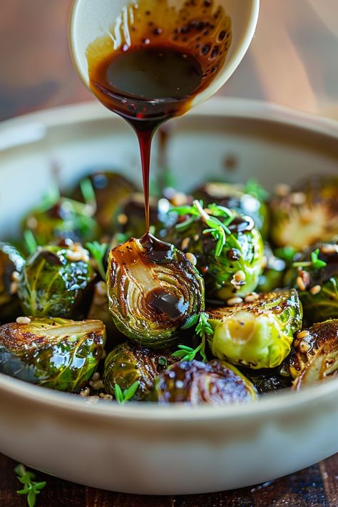 Balsamic glaze being drizzled over a dish of roasted Brussels sprouts garnished with fresh herbs. Honey Balsamic Glazed Brussel Sprouts, Honey Glaze Brussel Sprouts, Trader Joe’s Balsamic Glaze Recipes, Brussel Sprout Balsamic Glaze, Summer Brussel Sprout Recipes, Roasted Brussels Sprouts Oven, Balsamic Honey Brussel Sprouts, Recipes With Balsamic Glaze, Balsamic Glazed Brussel Sprouts