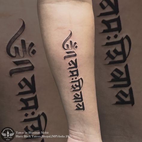 The shape of om has the face of a smiling Shiva that makes it a modern Indian design. This tattoo symbolizes peace and prosperity Omm namaha shivaya tattoo by - @illuminatimohit Only at Harry black tattoos dB city mall bhopal For consultation and appointment 07552514759/9981271965 #illuminatimohit #tattoolife #tattoobyilluminatimohit #ommnamahshivaya #tattoo Om Namah Shivaya Calligraphy, Ohm Namashivaya Tattoo, Smiling Shiva, Om Namah Shivaya Tattoo, Sanskrit Calligraphy, 19 Tattoo, Hanuman Tattoo, Harry Tattoos, Mahadev Tattoo