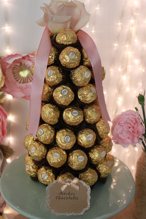 Ferrero Rocher tower Ferrero Rocher Tower Diy, Ferrero Rocher Tower, Chocolate Decoration, Felt Flower Tutorial, Soap Flowers, Indian Beadwork, Fairytale Party, Birthday Party Desserts, Creative Wedding Gifts