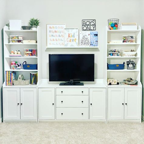 Follow Me On Instagram @alifemoreorganized - https://www.instagram.com/alifemoreorganized/ #playroom #playroomorganization #organizedplayroom #ikea #ikeaplayroom #ikeafurniture #ikeahauga #hauga #ikeabookshelf #bookshelf #bookshelves #whitebookshelf #wallshelf #wallshelves #shelfie #tvstand #toyorganization #organizedtoys #playroomdecor #playroominspo #playroomideas #playroomdesign #playroomgoals #playroomstorage #toystorage #craftsupplies #craftsupply #safariltd #lazysusan #organization Ikea Hauga Storage Playroom, Playroom With Black Furniture, Ikea Hauga Playroom, Playroom Storage With Tv, Playroom Organization With Tv, Ikea Bookshelf Playroom, Hauga Ikea Living Room, Ikea Playroom With Tv, Ikea Cabinets Playroom